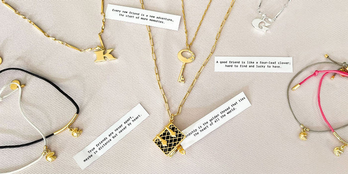 Jewelry with quotes for friendships over a light pink background
